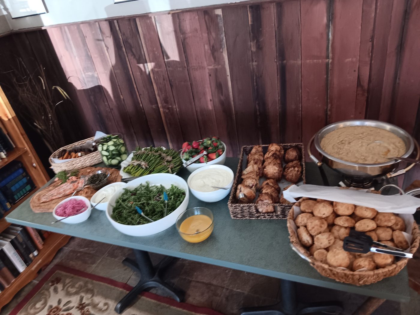 Full brunch buffet table with fresh greens and bread